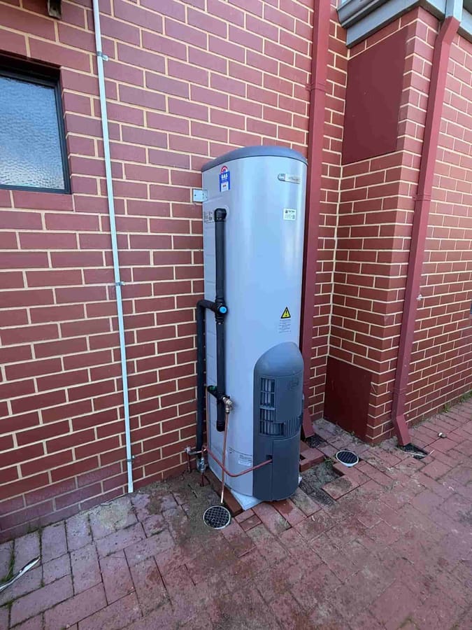 Gas storage hot water cylinder installed on the exterior wall of a Perth home
