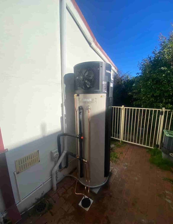 Heat pump hot water system with tank and compressor in a Perth backyard