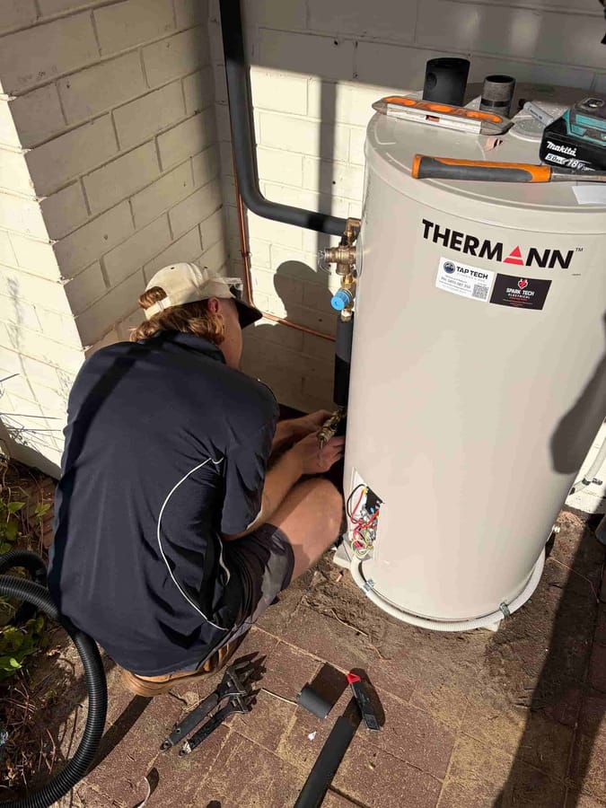 Tap Tech technician servicing an electric hot water storage tank in Perth